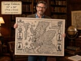Model Holding Large Old Map of Scotland