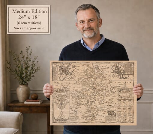 Model holding the medium edition of John Speed’s historic map of Warwickshire for size illustration