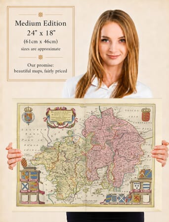 Lady holding the Medium Edition of Joan Blaeu's old map of Warwickshire And Worcestershire